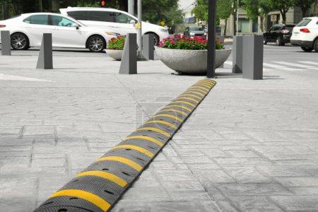 Photo for City street with striped plastic speed bump - Royalty Free Image