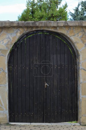 Foto de Entrance of building with beautiful arched wooden door outdoors - Imagen libre de derechos