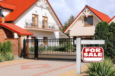 Téléchargez les photos : Signe rouge avec des mots à vendre près de la belle maison en plein air - en image libre de droit