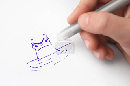 Photo for Child erasing drawing with erasable pen on paper sheet, closeup - Royalty Free Image