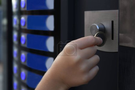 Photo for Using coffee vending machine. Girl inserting coin into acceptor, closeup - Royalty Free Image