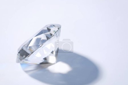 Photo for Beautiful dazzling diamond on white background, closeup. Space for text - Royalty Free Image