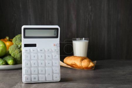 Photo for Calculator and food products on dark grey table, space for text. Weight loss concept - Royalty Free Image