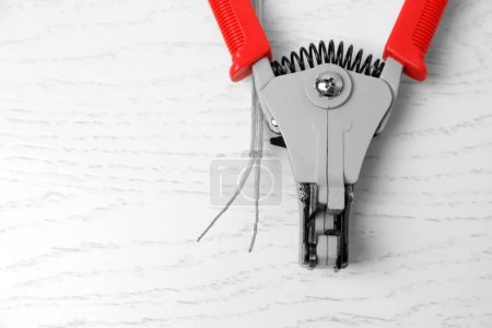 Photo for Professional cutters and cable with stripped wire on white wooden table, flat lay. Space for text - Royalty Free Image