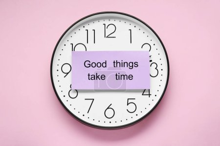 Photo for Card with phrase Good Things Take Time and clock on pink background, top view. Motivational quote - Royalty Free Image
