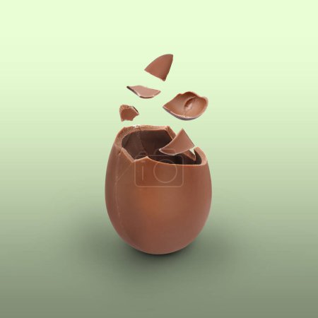 Photo for Broken milk chocolate egg on color background - Royalty Free Image