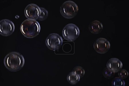 Photo for Many beautiful soap bubbles on black background - Royalty Free Image