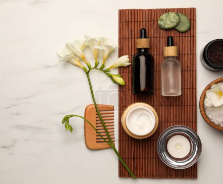 Photo for Flat lay composition with different spa products and flowers on white marble table - Royalty Free Image