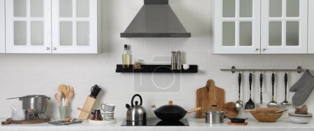 Countertop with different cooking utensils in kitchen, banner design