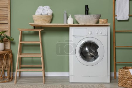 Photo for Stylish laundry room with functional washing machine. Interior design - Royalty Free Image