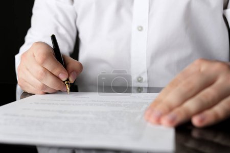 Téléchargez les photos : Document de signature notarié à table noire, gros plan - en image libre de droit