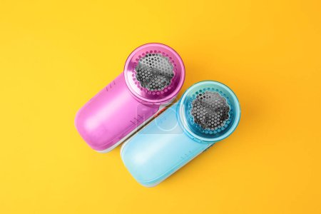 Photo for Modern fabric shavers on yellow background, flat lay - Royalty Free Image