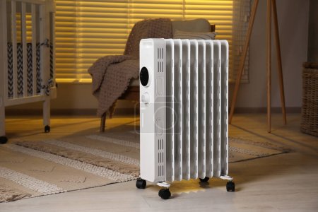 Photo for Modern portable electric heater in child room - Royalty Free Image