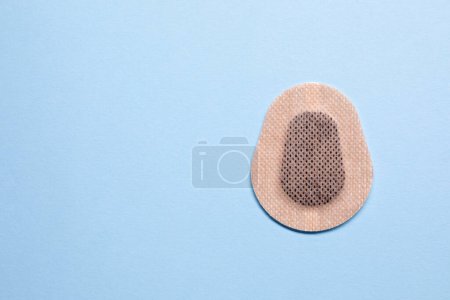 Photo for Contraceptive patch on light blue background, top view. Space for text - Royalty Free Image