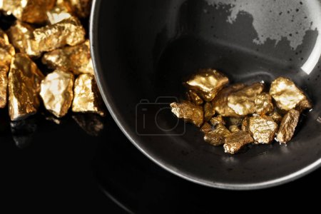 Photo for Bowl with gold nuggets on black background, closeup - Royalty Free Image