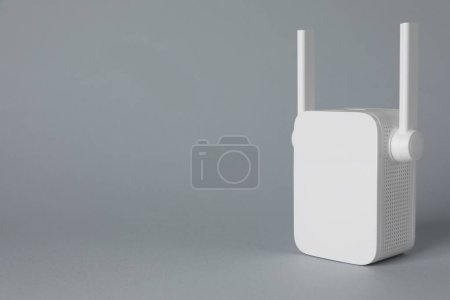 New modern Wi-Fi repeater on light gray background, space for text