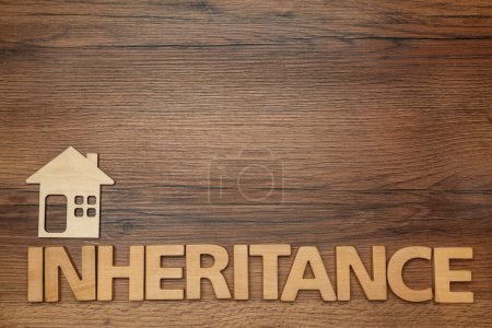 Photo for Word Inheritance made with letters and house model on wooden background, flat lay. Space for text - Royalty Free Image