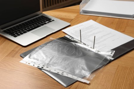 Photo for File folder with punched pockets on wooden table - Royalty Free Image
