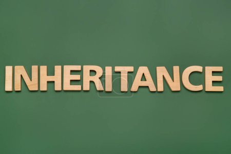 Photo for Word Inheritance made with wooden letters on green background, flat lay - Royalty Free Image