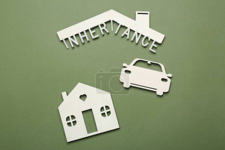Photo for Word Inheritance, car and house models on green background, flat lay - Royalty Free Image