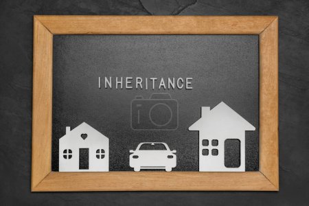 Photo for Board with word Inheritance and different cutouts on black background, top view - Royalty Free Image