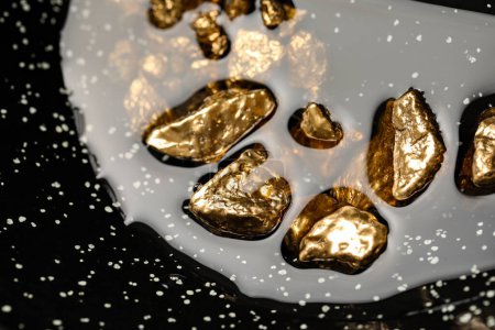 Photo for Pile of shiny gold nuggets in water, closeup view - Royalty Free Image