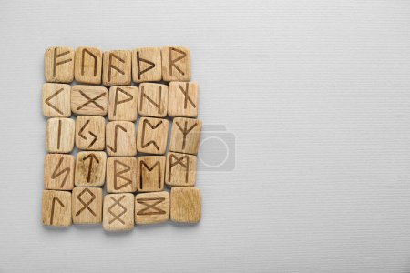 Photo for Wooden runes on white background, top view. Space for text - Royalty Free Image