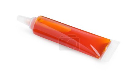 Téléchargez les photos : Tube avec colorant alimentaire orange sur fond blanc - en image libre de droit