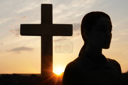 Photo for Atheism. Silhouette of woman turned away from Christian cross outdoors at sunrise - Royalty Free Image