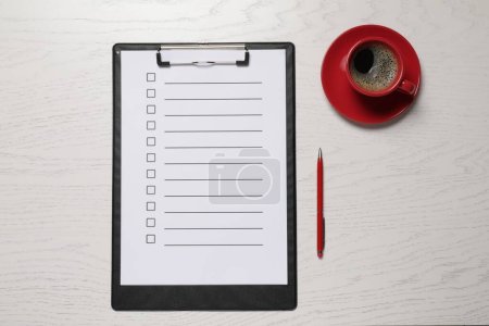Photo for Clipboard with checkboxes, cup of coffee and pen on white wooden table, flat lay. Checklist - Royalty Free Image