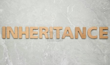 Photo for Word Inheritance made with wooden letters on light marble background, flat lay - Royalty Free Image