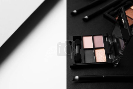 Photo for Eye shadow palettes and professional makeup brushes on colorful background, space for text - Royalty Free Image