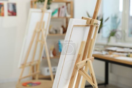 Wooden easel with canvas in artist's studio. Creative hobby