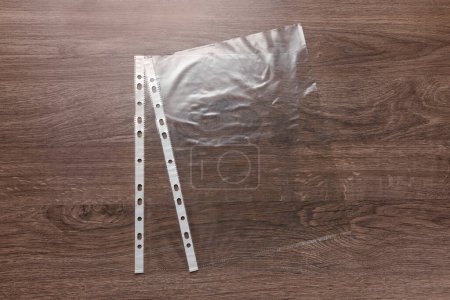 Photo for Punched pockets on wooden table, flat lay - Royalty Free Image
