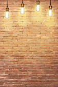 Many pendant lamps against old brick wall Poster #649881172