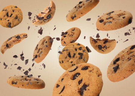 Photo for Tasty chocolate chip cookies falling on pale light brown background - Royalty Free Image