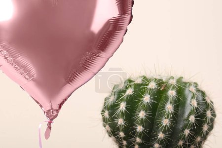 Photo for Pink balloon near cacti on beige background - Royalty Free Image