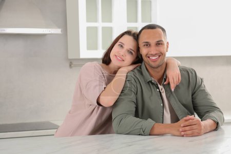 Photo for Dating agency. Happy couple spending time together in kitchen, space for text - Royalty Free Image