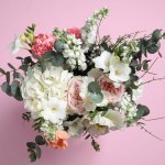 Bouquet of beautiful flowers on pink background, top view