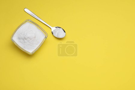 Photo for Sweet powdered fructose on yellow background, flat lay. Space for text - Royalty Free Image