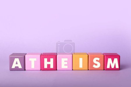 Photo for Word Atheism made of cubes with letters on violet background - Royalty Free Image