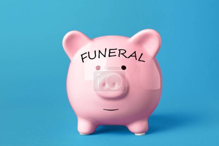 Money for funeral expenses. Pink piggy bank on light blue background