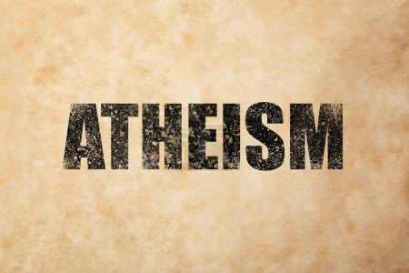 Photo for Black word Atheism on beige textured background. Philosophical or religious position - Royalty Free Image