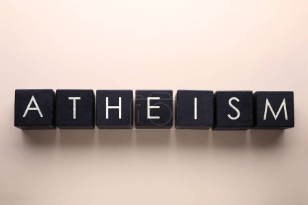 Photo for Word Atheism made of black wooden squares with letters on beige background, top view - Royalty Free Image