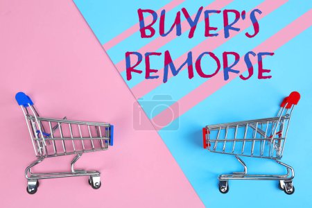 Photo for Text Buyer's Remorse and shopping carts on pink and light blue background, top view - Royalty Free Image