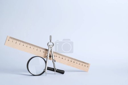 Photo for Ruler, magnifying glass and compass on white background - Royalty Free Image