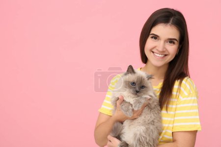 Happy woman hugging her cute cat on pink background, space for text Poster 655202836