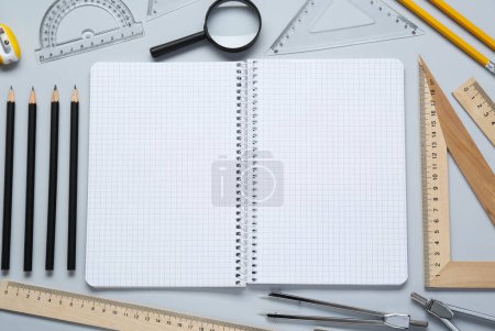 Photo for Different rulers, notebook and other stationery for drawing on light grey background, flat lay - Royalty Free Image