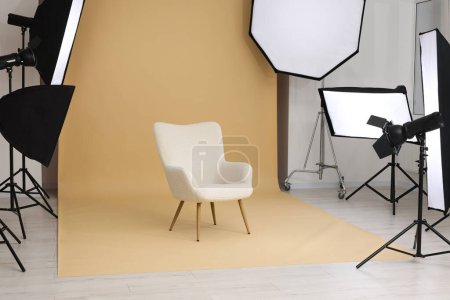 Foto de Interior of modern photo studio with armchair and professional lighting equipment - Imagen libre de derechos