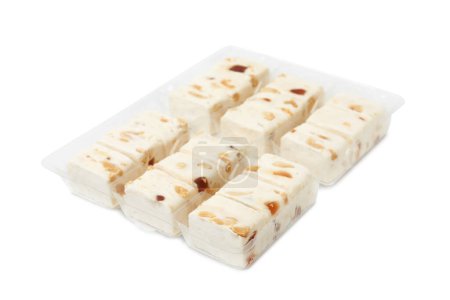 Photo for Plastic containers with pieces of nougat on white background - Royalty Free Image